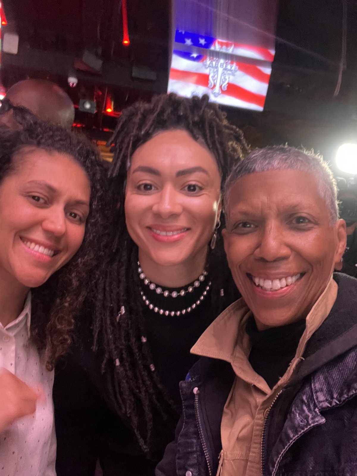 Three smiling women from the Fight Goddess community together at an event